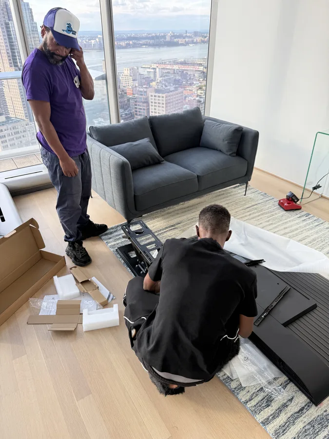 Crew working on furniture assembly in a living room
