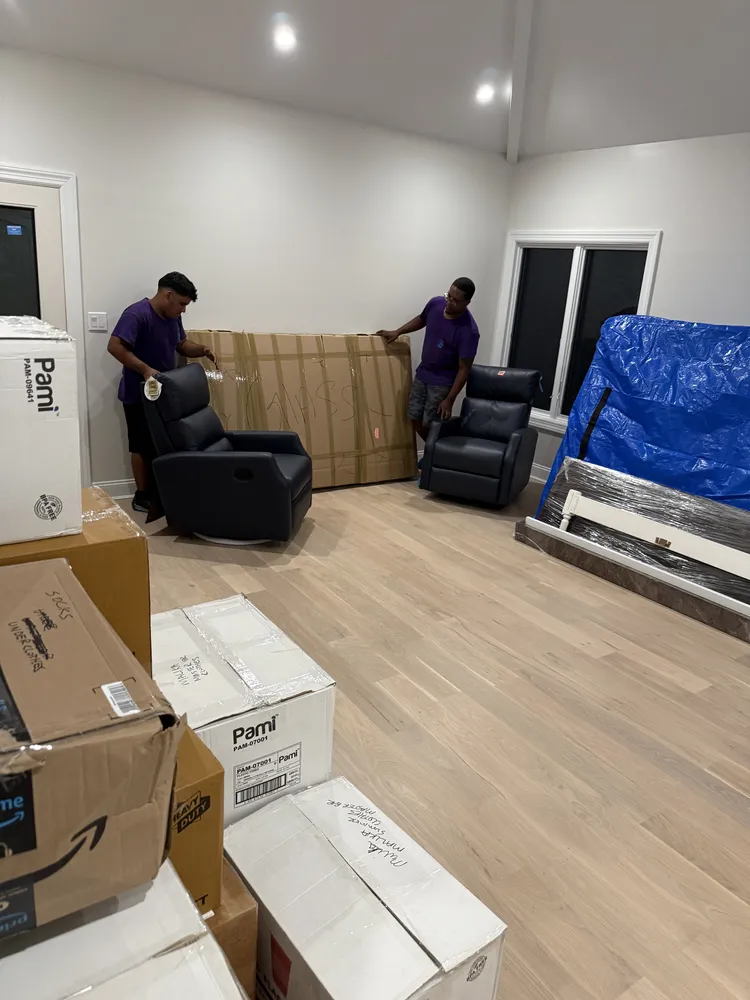 Moving Genie crew working with moving boxes and furniture indoors